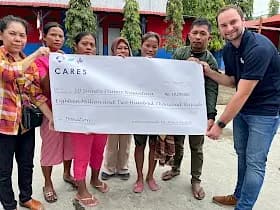Crane Worldwide Logistics team presenting a community fundraising check